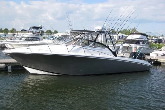  Yacht Photos Pics 2007 Fountain 33 Sportfish Cruiser docked, featuring sleek design and fishing rods.