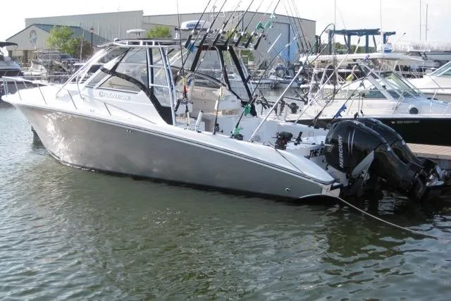  Yacht Photos Pics 2007 Fountain 33 Sportfish Cruiser docked, equipped with fishing rods and outboard motors.