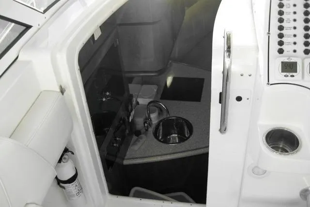 Yacht Photos Pics 2007 Fountain 33 Sportfish Cruiser interior with sink and control panel.