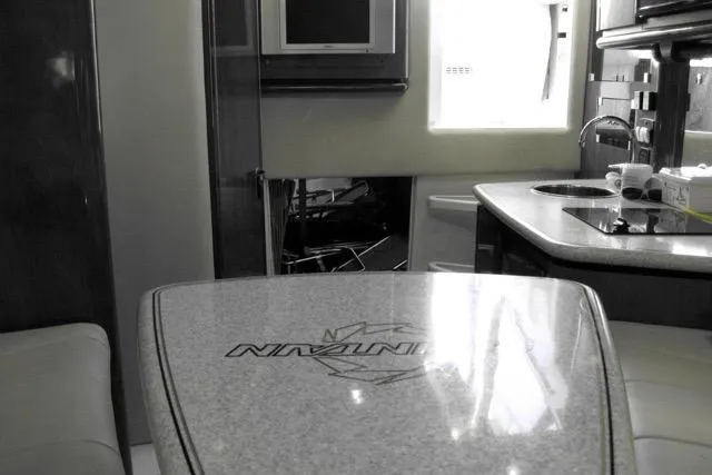  Yacht Photos Pics 2007 Fountain 33 Sportfish Cruiser interior with kitchenette and seating area.