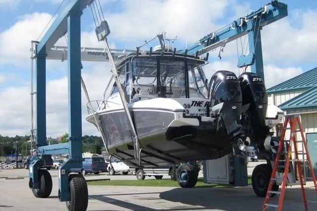  Yacht Photos Pics 2007 Fountain 33 Sportfish Cruiser lifted by a boat hoist at a marina.