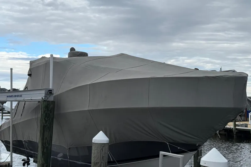  Yacht Photos Pics Covered 2007 Fountain 33 Sportfish Cruiser docked at marina under cloudy sky.