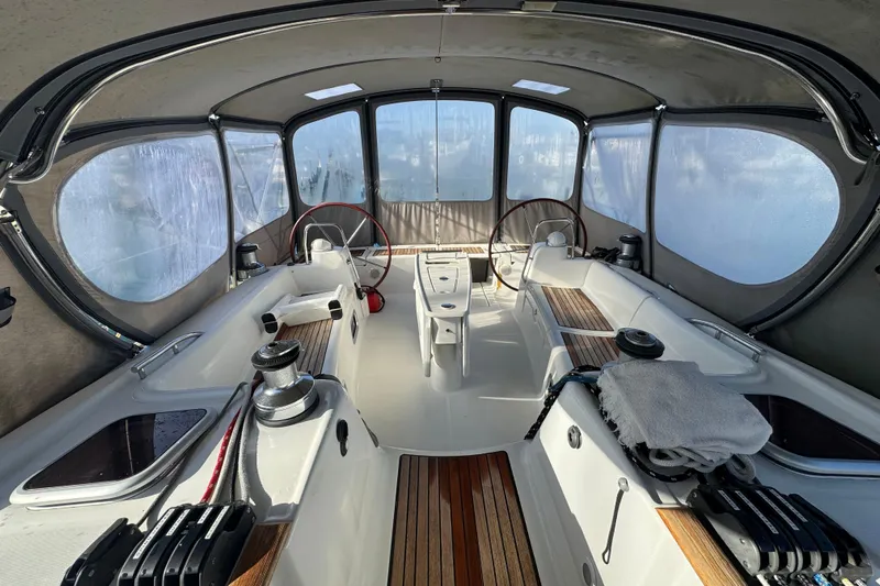 Wakadui Yacht Photos Pics 2009 Benetea 49 yacht cockpit with dual steering wheels and covered seating area.