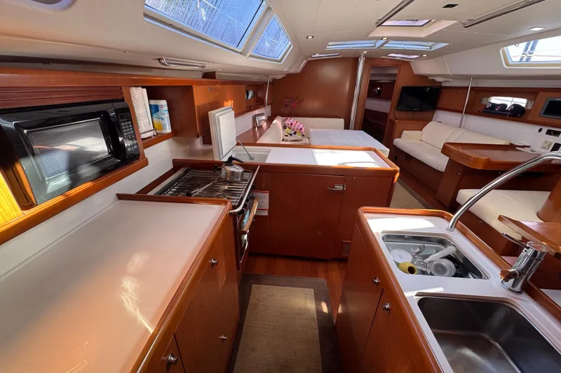Wakadui Yacht Photos Pics Luxurious interior of a 2009 Benetea 49 yacht with modern kitchen and seating area.