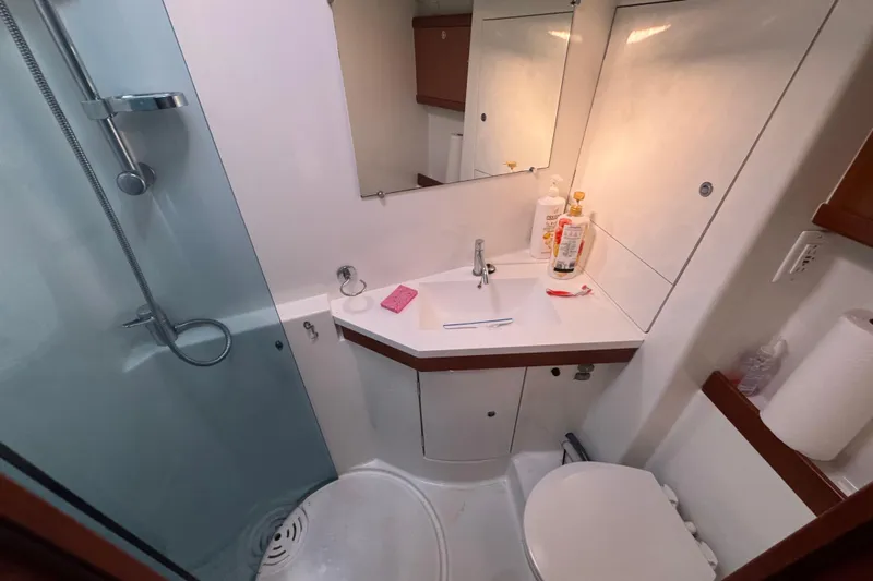Wakadui Yacht Photos Pics Compact bathroom in a 2009 Benetea 49 yacht, featuring a shower, sink, and toilet.