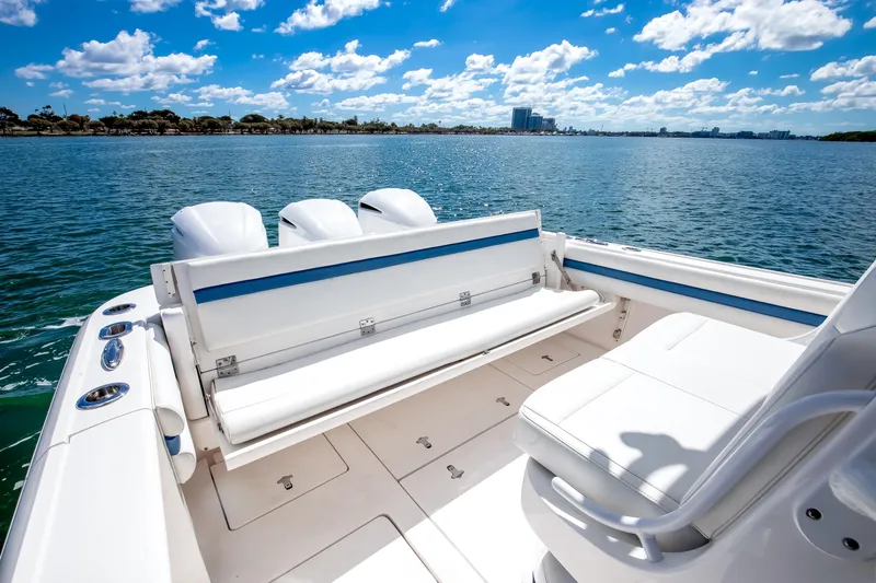  Yacht Photos Pics 2017 Intrepid 375 Center Console boat with seating, on a sunny day, overlooking calm waters.