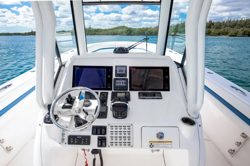  Yacht Photos Pics 2017 Intrepid 375 Center Console boat dashboard with navigation screens and steering wheel.