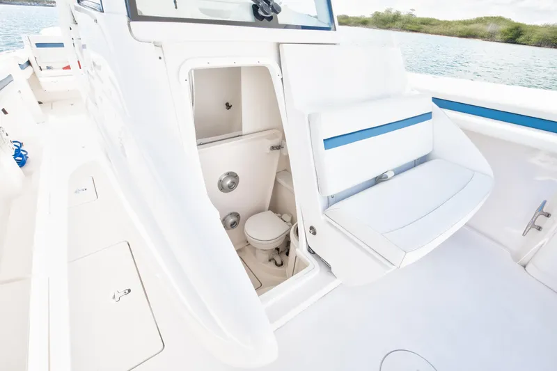  Yacht Photos Pics 2017 Intrepid 375 Center Console boat interior with open bathroom compartment.