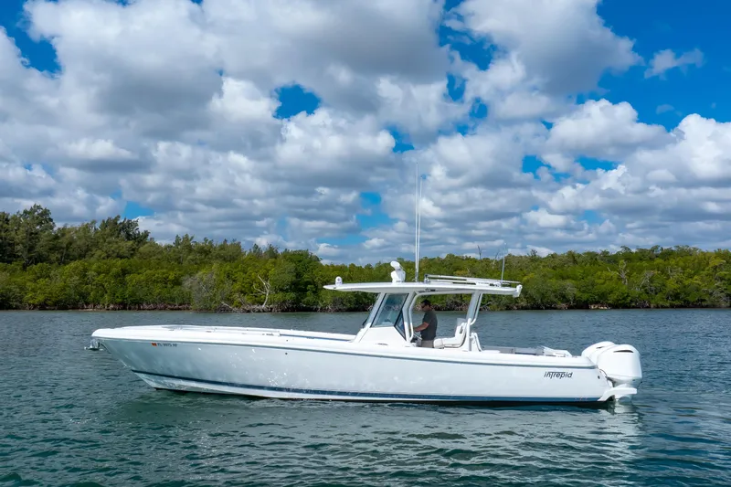  Yacht Photos Pics 2017 Intrepid 375 Center Console boat on calm water under a cloudy sky.