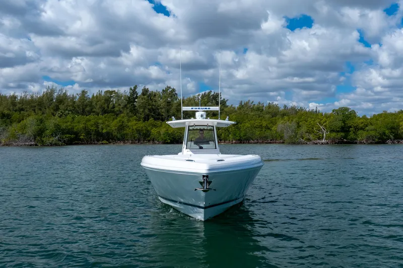  Yacht Photos Pics 2017 Intrepid 375 Center Console boat on calm water with cloudy sky backdrop.