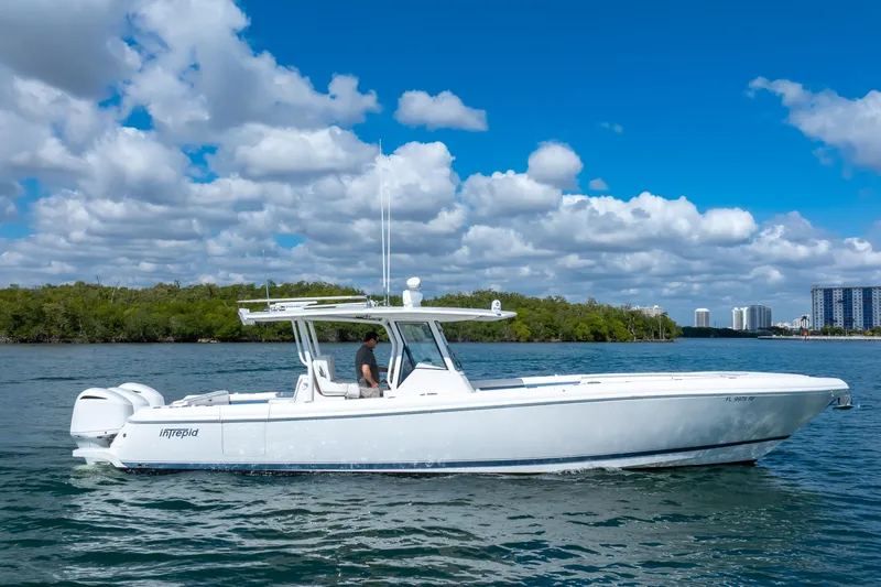  Yacht Photos Pics 2017 Intrepid 375 Center Console boat cruising on a sunny day with blue skies.