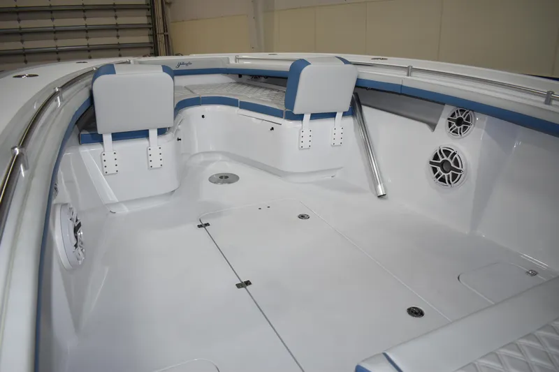 Now In Stock Yacht Photos Pics 2024 Yellowfin 34 boat interior with white and blue seating and speakers.