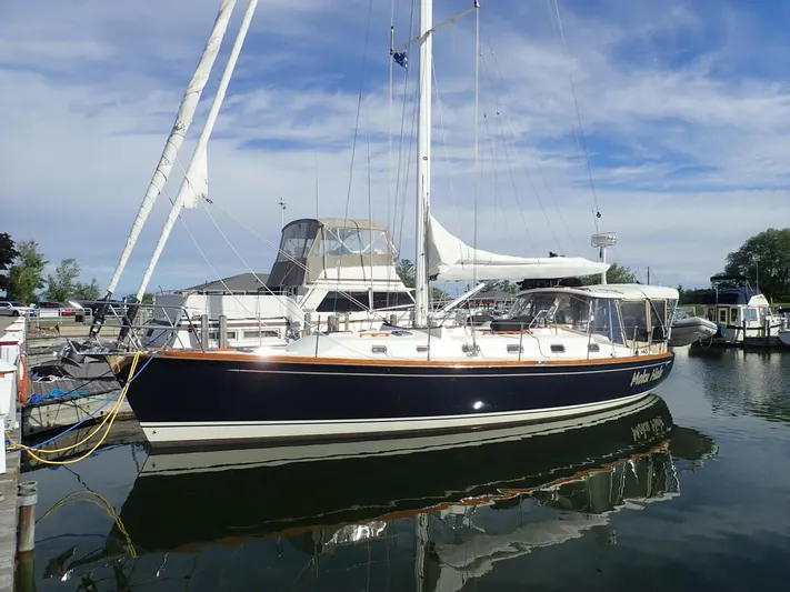  Yacht Photos Pics Sailboat Tartan 4300, 2011 model, docked in a marina under a clear sky.