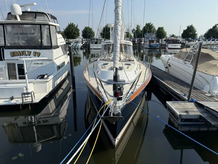  Yacht Photos Pics Sailboat Tartan 4300, 2011 model, docked between yachts in a marina.
