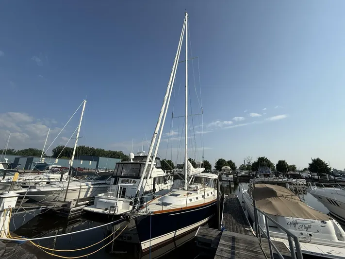  Yacht Photos Pics Sailboats docked at marina, featuring a 2011 Tartan 4300 under clear blue sky.