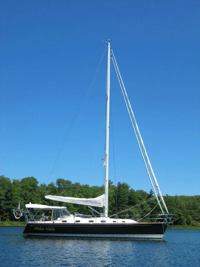  Yacht Photos Pics Sailboat Tartan 4300, 2011 model, on calm water under clear blue sky.