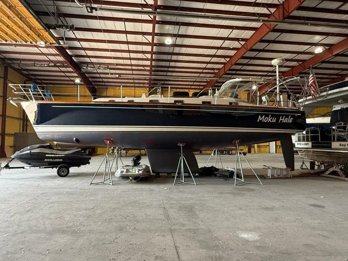  Yacht Photos Pics Tartan 4300 sailboat from 2011 in a warehouse, supported by stands.