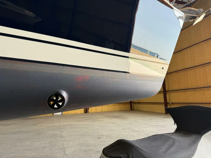  Yacht Photos Pics Tartan 4300 sailboat hull in a warehouse, showcasing sleek design and propeller detail.