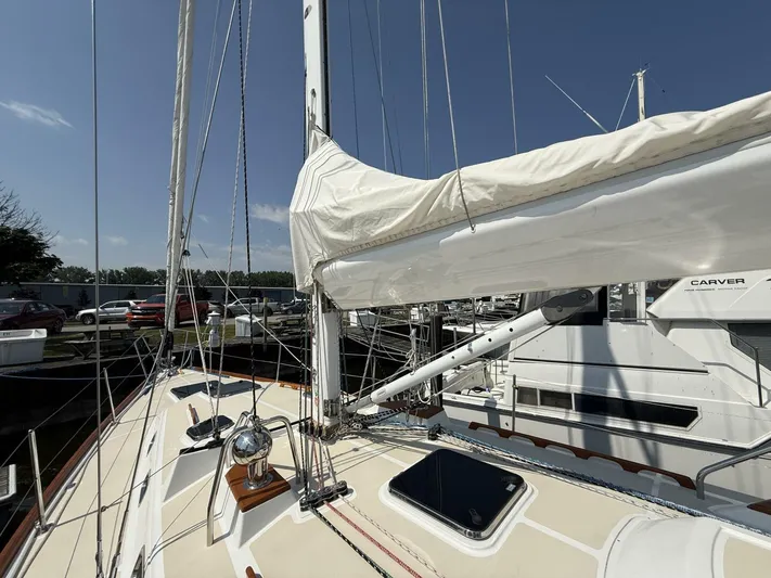  Yacht Photos Pics Sailboat deck view of 2011 Tartan 4300 with mast and rigging under clear sky.