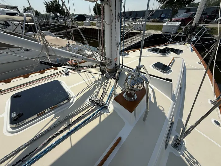  Yacht Photos Pics Sailboat deck of 2011 Tartan 4300 with rigging and hatches in marina setting.