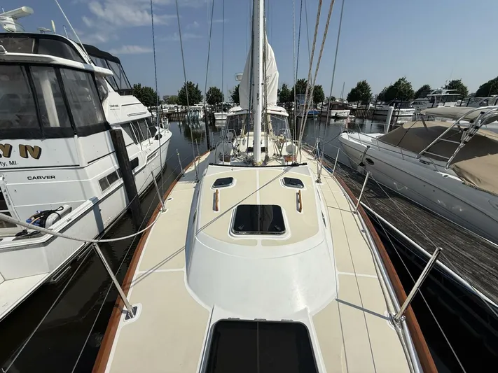  Yacht Photos Pics Sailboat docked in marina, Tartan 4300, 2011 model, surrounded by other boats.