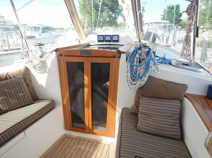  Yacht Photos Pics Cozy interior of 2011 Tartan 4300 sailboat with cushions and nautical ropes.