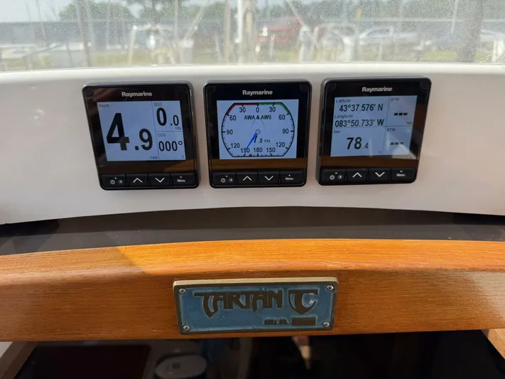  Yacht Photos Pics Tartan 4300 yacht dashboard with Raymarine displays showing navigation and depth data.