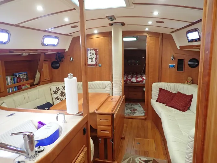  Yacht Photos Pics Luxurious interior of 2011 Tartan 4300 yacht with cozy seating and wooden finishes.