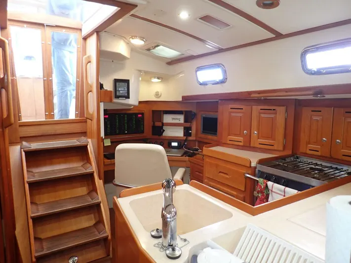  Yacht Photos Pics Interior of 2011 Tartan 4300 yacht with wooden cabinetry and modern amenities.