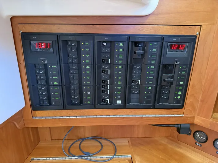  Yacht Photos Pics Electrical control panel on a 2011 Tartan 4300 yacht, featuring multiple switches and digital displays.