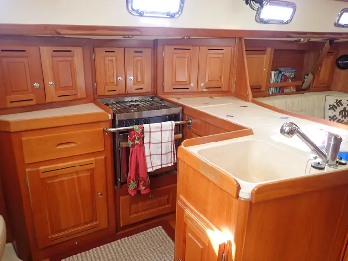  Yacht Photos Pics Luxurious 2011 Tartan 4300 yacht kitchen with wooden cabinetry and modern amenities.
