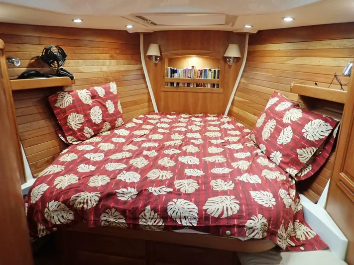  Yacht Photos Pics Luxurious Tartan 4300 yacht cabin with wooden interior and tropical-themed bedding, 2011 model.