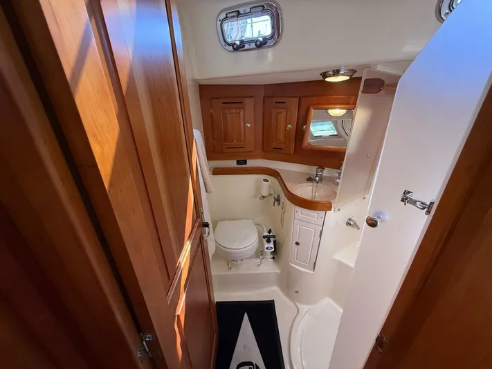  Yacht Photos Pics Luxurious Tartan 4300 yacht bathroom with wooden cabinetry and modern fixtures, 2011 model.