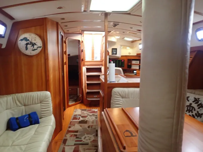  Yacht Photos Pics Luxurious interior of 2011 Tartan 4300 yacht with wooden finishes and comfortable seating.