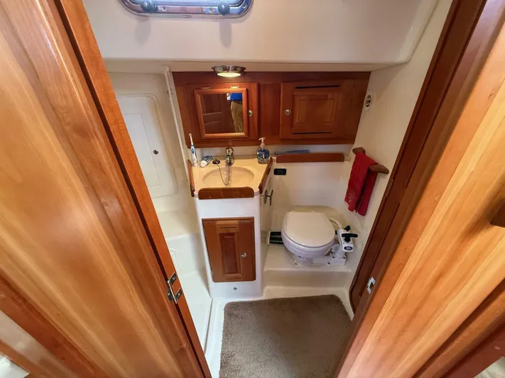  Yacht Photos Pics Compact bathroom in 2011 Tartan 4300 yacht with wooden cabinetry and modern fixtures.