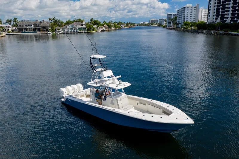  Yacht Photos Pics 2021 SeaVee 390Z boat cruising on a scenic waterway with luxury homes in the background.