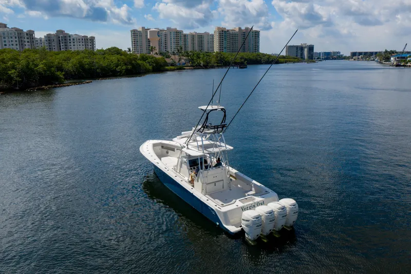  Yacht Photos Pics 2021 SeaVee 390Z boat cruising on a scenic waterway with city skyline.