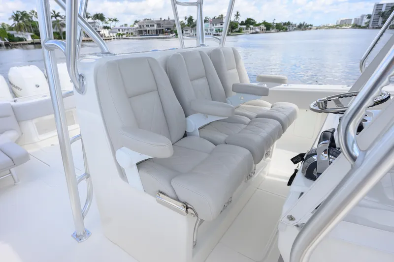  Yacht Photos Pics 2021 SeaVee 390Z boat interior with luxurious seating and steering wheel, overlooking waterfront homes.