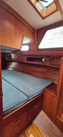 Blue Skies Yacht Photos Pics Cozy cabin interior of 1990 Able Chuck Paine Sloop with wooden finish and skylight.