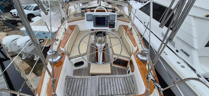 Blue Skies Yacht Photos Pics 1990 Able Chuck Paine Sloop cockpit with wooden accents and navigation equipment.
