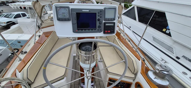 Blue Skies Yacht Photos Pics Cockpit of 1990 Able Chuck Paine Sloop with navigation instruments and steering wheel.