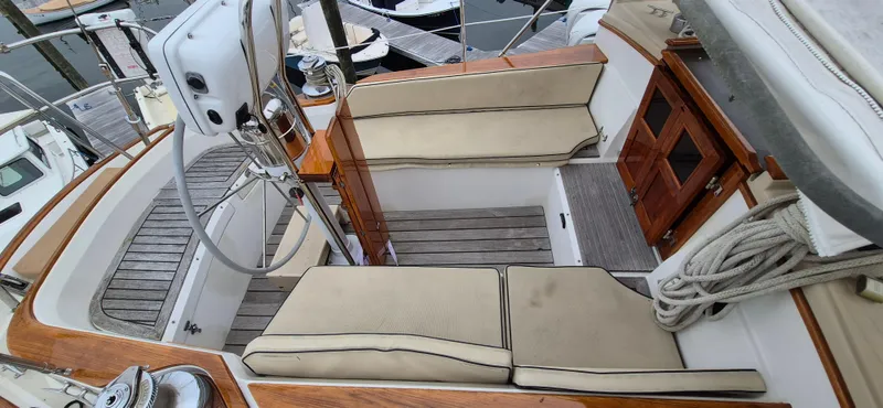 Blue Skies Yacht Photos Pics 1990 Able Chuck Paine Sloop cockpit with wooden accents and cushioned seating.