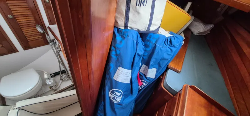 Blue Skies Yacht Photos Pics Interior of 1990 Able Chuck Paine Sloop with wooden cabinetry and marine toilet.