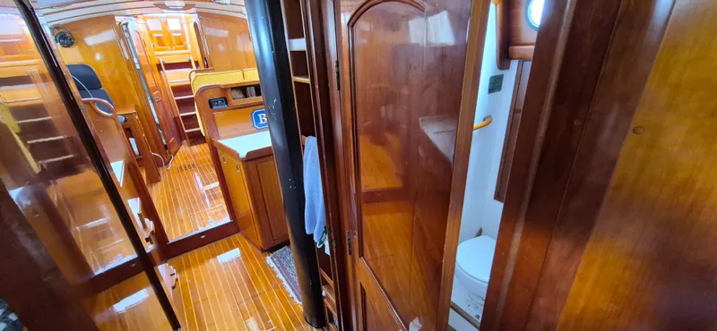 Blue Skies Yacht Photos Pics Interior of 1990 Able Chuck Paine Sloop, featuring polished wood and compact design.