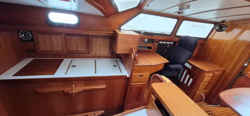 Blue Skies Yacht Photos Pics Interior of 1990 Able Chuck Paine Sloop with wooden cabinetry and navigation station.