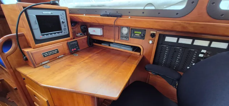 Blue Skies Yacht Photos Pics Navigation station of 1990 Able Chuck Paine Sloop with control panels and equipment.