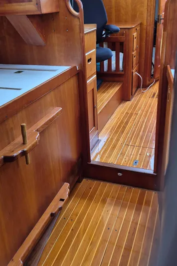 Blue Skies Yacht Photos Pics Interior of 1990 Able Chuck Paine Sloop with wooden flooring and cabinetry.