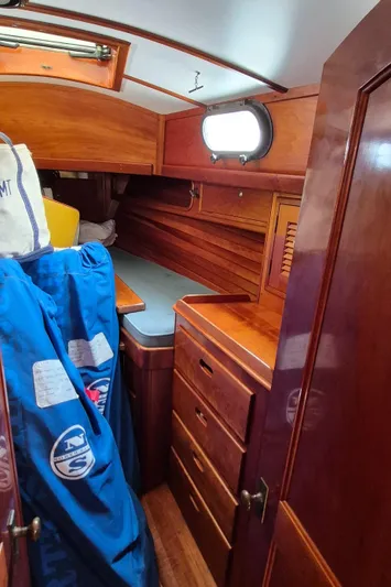 Blue Skies Yacht Photos Pics Interior of 1990 Able Chuck Paine Sloop with wooden cabinetry and storage.