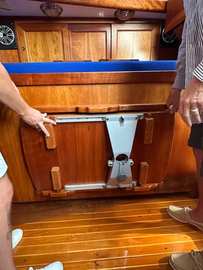 Blue Skies Yacht Photos Pics Interior of 1990 Able Chuck Paine Sloop with wooden cabinetry and foldable table mechanism.