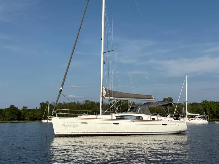 Farenheight Yacht Photos Pics 2008 Beneteau Oceanis 40 sailboat on calm water under clear blue sky.